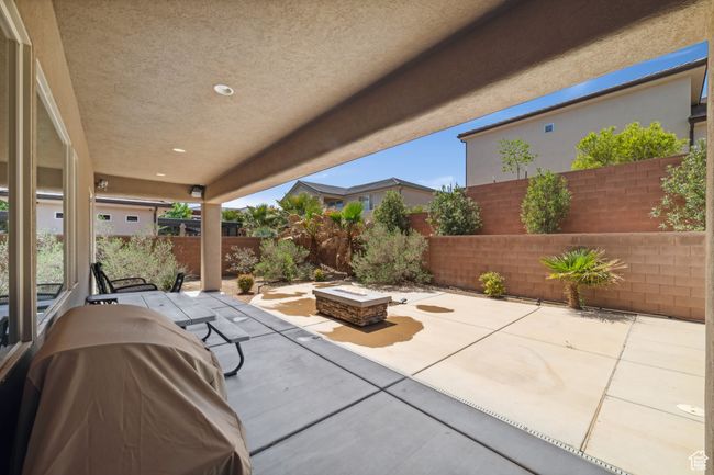 View of patio / terrace with a fenced backyard and a fire pit | Image 33