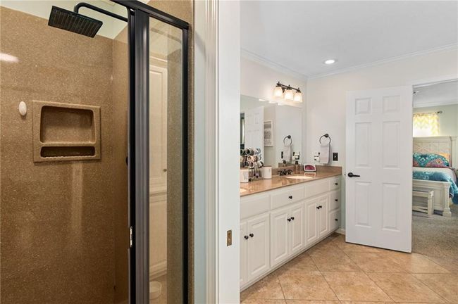 Bathroom with vanity, tile patterned floors, ornamental molding, and walk in shower | Image 30