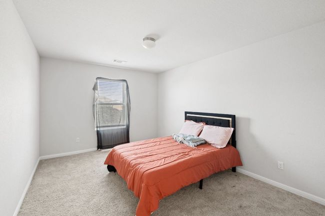 Bedroom featuring visible vents, baseboards, and carpet | Image 25