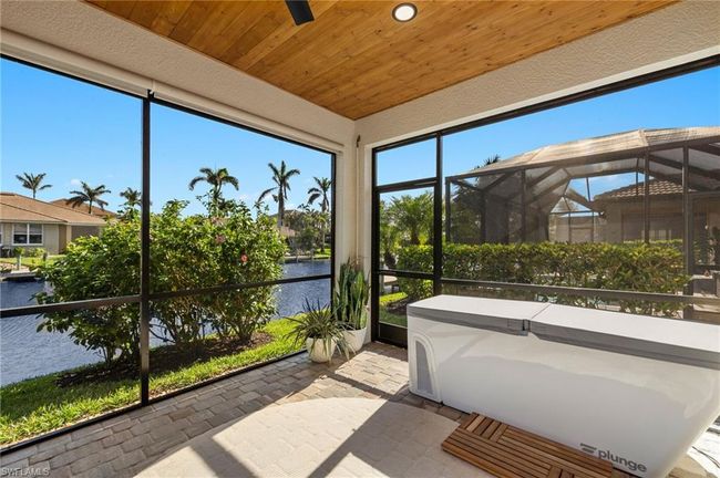 Sunroom featuring a water view and wooden ceiling | Image 28