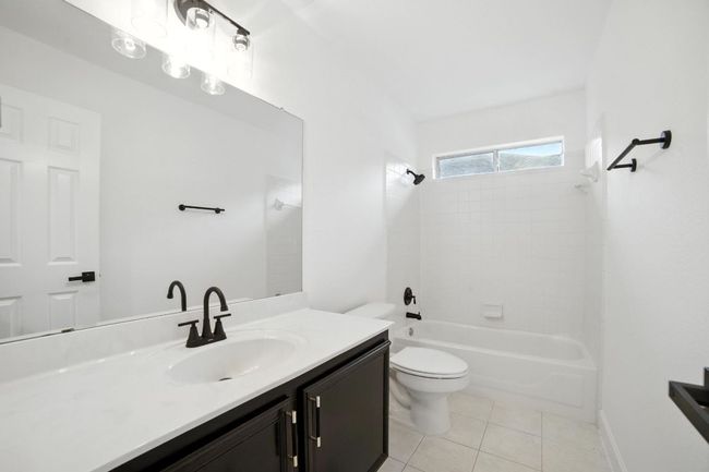 Additional upgrades include fresh interior paint, modern ceiling fans, designer light fixtures, stylish door hardware, new faucets, and modern showerheads throughout. | Image 23