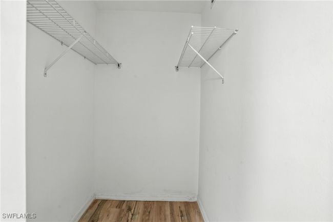 Spacious closet featuring light wood-style flooring | Image 30