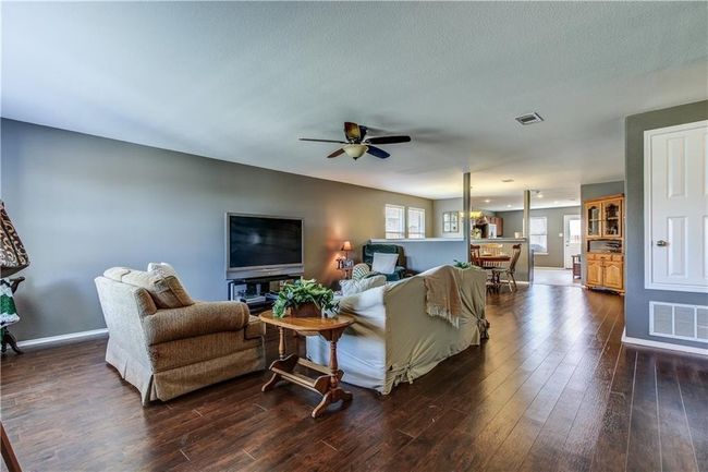 Living area featuring dark wood finished floors and a ceiling fan | Image 17