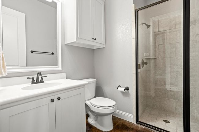 Bathroom featuring toilet, a stall shower, and vanity | Image 25