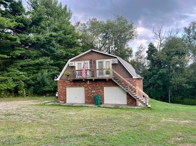 View of outdoor structure with a lawn | Image 2