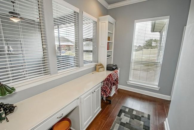 Office Nook has desk area for 2 people and built in shelves and cabinets. Overlooks the screened in patio and golf course. | Image 17