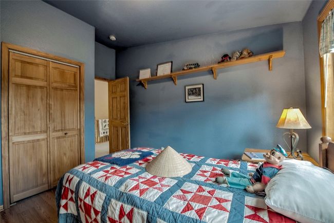 Bedroom with wood finished floors and a closet | Image 30