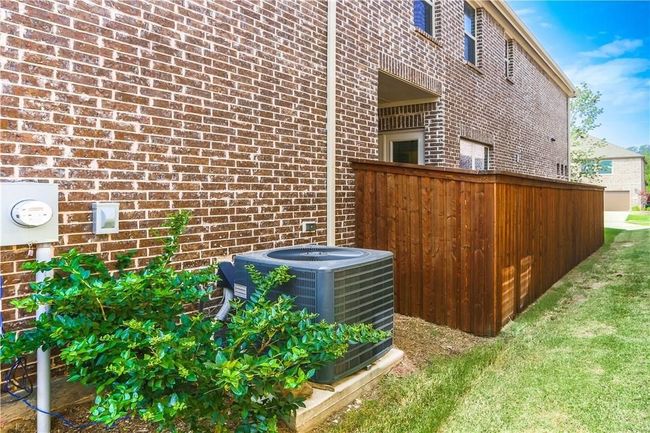 View of side of home featuring a central AC unit and brick siding | Image 32