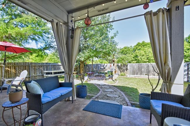 Kick back and relax under your covered extended patio that overlooks the fully fenced backyard. | Image 27