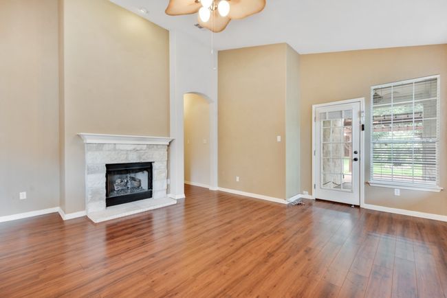 The main living area centers around a cozy fireplace, with effortless flow into the kitchen and dining space—perfect for gathering with friends and family. | Image 18