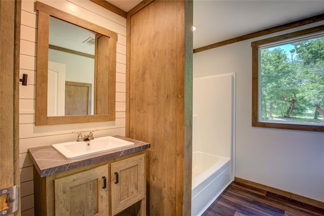 Bathroom featuring vanity, wood finished floors, and a tub | Image 21