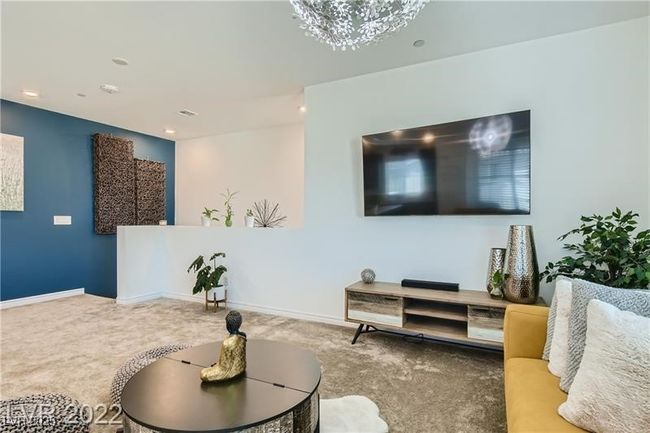 Living area with recessed lighting, an inviting chandelier, carpet flooring, and baseboards | Image 15