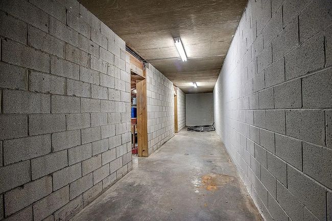The full 3, 000 sq ft basement includes a storm-safe room under the front porch and space ready for storage, a workshop, or custom finish | Image 37