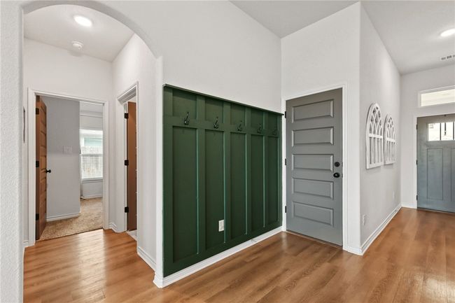 Entryway featuring light wood finished floors, plenty of natural light, and arched walkways | Image 9