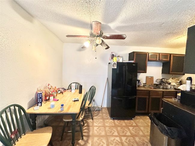 Dining room with a ceiling fan, a textured ceiling, and light flooring | Image 6