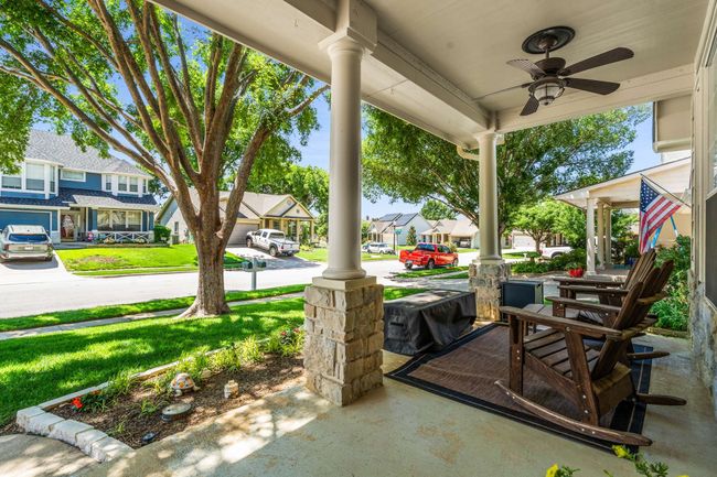 Welcome home to this front porch community! Covered porch featuring ceiling fan, a residential view, and a yard. | Image 5