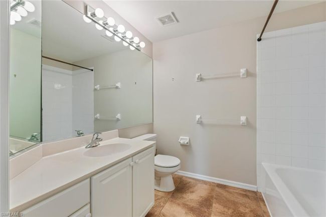 Full bathroom with visible vents, washtub / shower combination, baseboards, toilet, and vanity | Image 30