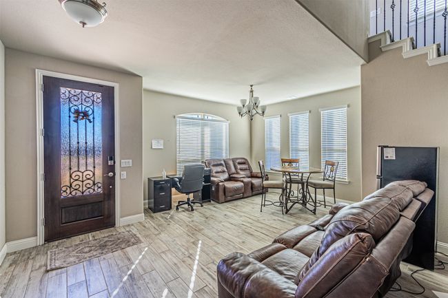 Entrance foyer featuring a chandelier, baseboards, and wood finished floors | Image 6