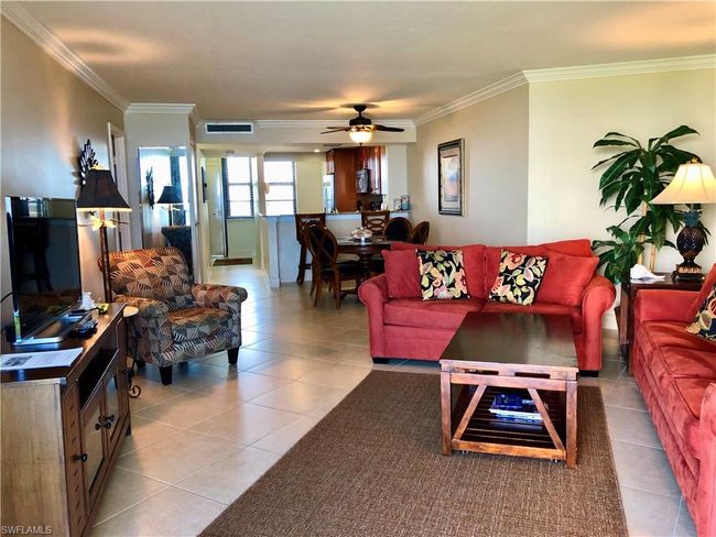 Living area featuring light tile patterned floors, visible vents, ornamental molding, and a ceiling fan | Image 10