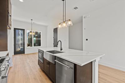 Dining space with light hardwood / wood-style floors and an inviting chandelier | Image 3