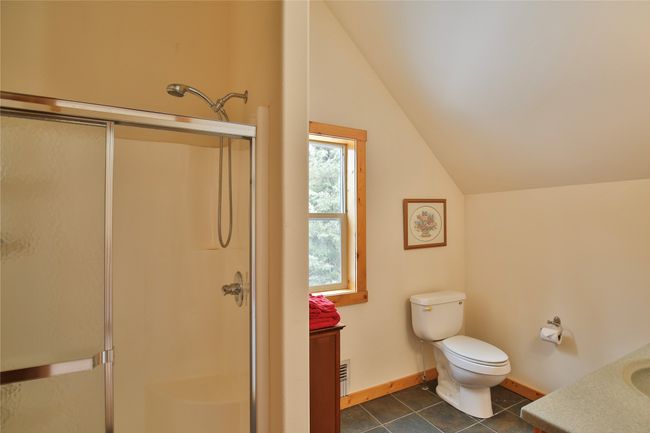 Bathroom featuring vanity, a shower stall, toilet, and vaulted ceiling 2nd suite upstairs | Image 29