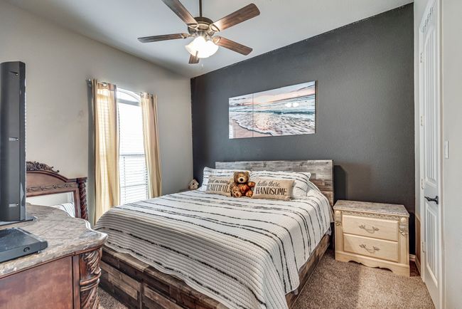 Carpeted bedroom with ceiling fan | Image 8