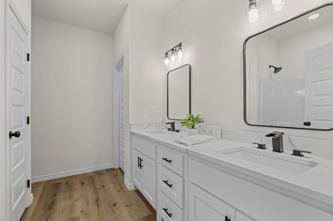 Bathroom featuring vanity, walk in shower, and hardwood / wood-style floors | Image 37