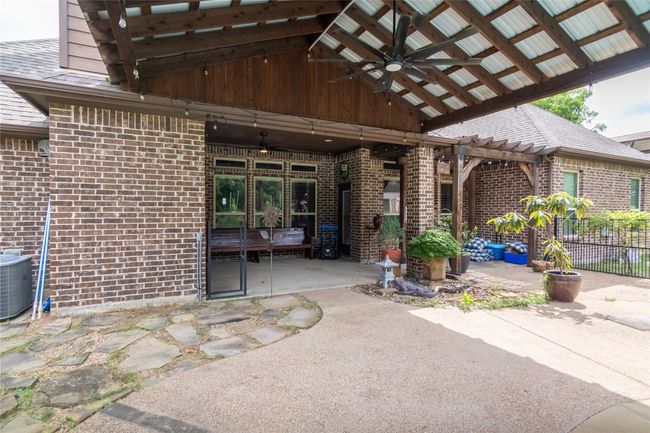 View of patio featuring a ceiling fan, central air condition unit, and a pergola | Image 30