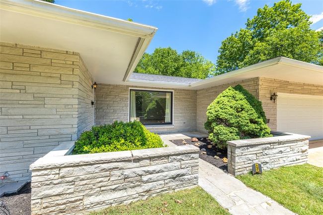 View of exterior entry with an attached garage and brick siding | Image 21