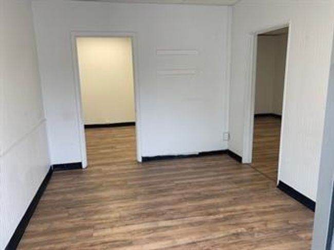 Empty room with wood finished floors | Image 4
