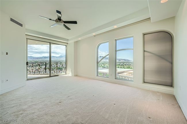 Empty room featuring a ceiling fan, carpet, baseboards, and a mountain view | Image 17