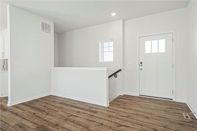 Entryway featuring a healthy amount of sunlight and dark wood-type flooring | Image 3