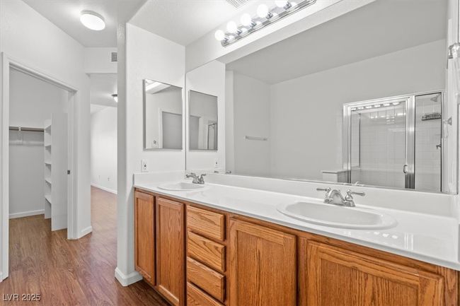 The sequestered primary suite is a true retreat, offering a large walk-in closet and a spa-inspired en suite bath with dual vanities, a soaking tub, and a separate walk-in shower. | Image 23