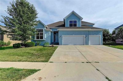 View of front of property with a garage and a front yard | Image 1