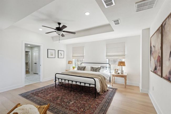 An airy primary suite with beautiful trayed ceilings and sunlight streaming in, perfect for unwinding. | Image 15