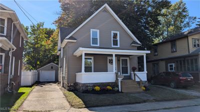 View of front facade featuring an outbuilding, a porch, and a garage | Image 2