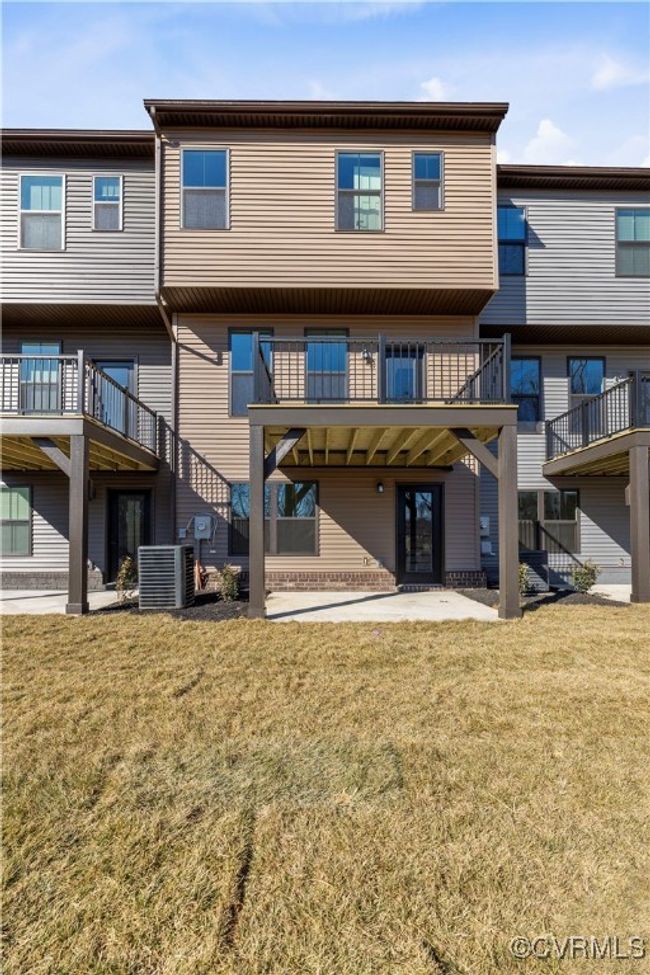 Rear view of property featuring central AC and a yard | Image 25