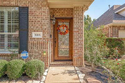 Prepare to impress as you welcome guests through your stunning mahogany front door, beautifully adorned with elegant leaded glass. This striking entrance creates an immediate "wow" factor, setting the tone for a warm and inviting atmosphere throughout your home. Stained Front Door refinishing is covered once every three years as part of your HOA fee. | Image 3