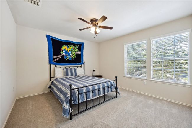 Bedroom with carpet and a ceiling fan | Image 7
