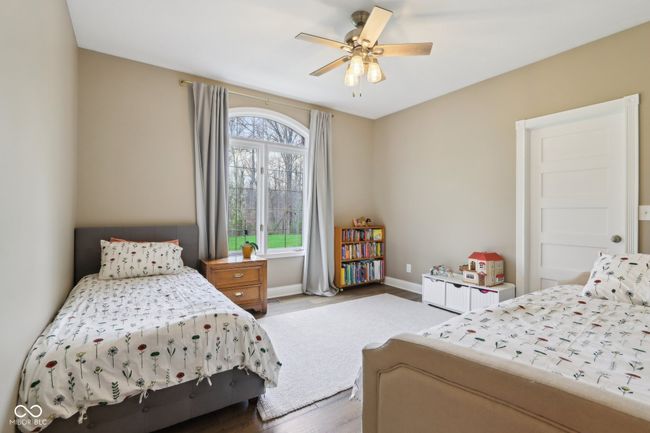 bedroom featuring baseboards, wood finished floors, and ceiling fan | Image 35