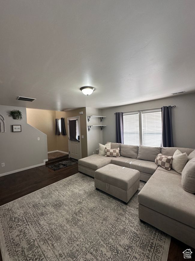 Living room with baseboards, wood finished floors, and visible vents | Image 5