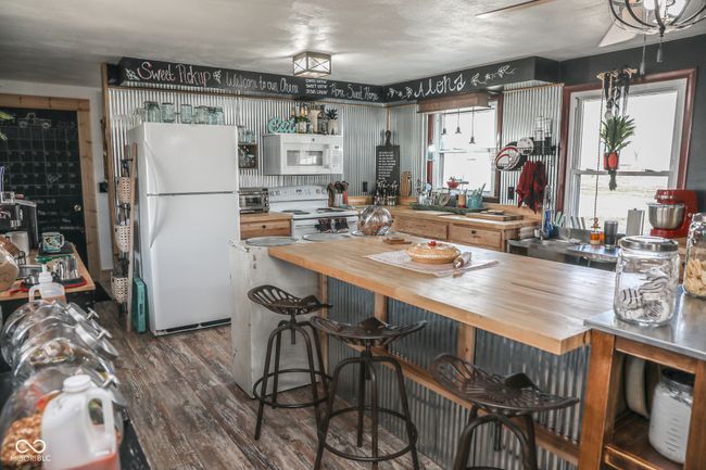 kitchen with a kitchen bar, white appliances, butcher block counters, and dark wood-type flooring | Image 22