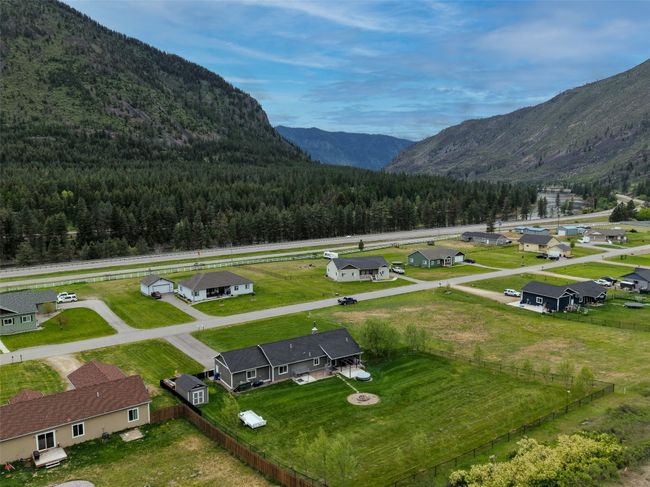 View of mountain backdrop featuring a forest and nearby suburban area | Image 38