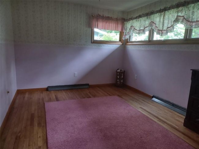 Spare room featuring hardwood / wood-style floors and a baseboard radiator | Image 10