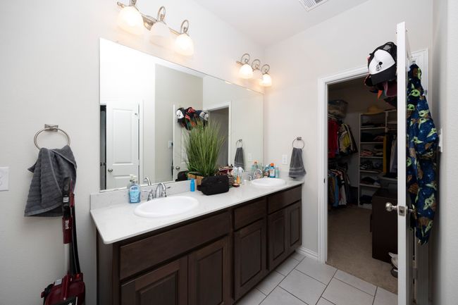 Bathroom featuring tile patterned floors, double vanity, and a walk in closet | Image 33