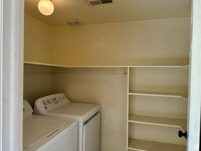 Laundry room featuring separate washer and dryer and convenient shelves | Image 14