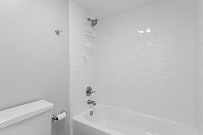 Bathroom with shower / bath combination and toilet | Image 26