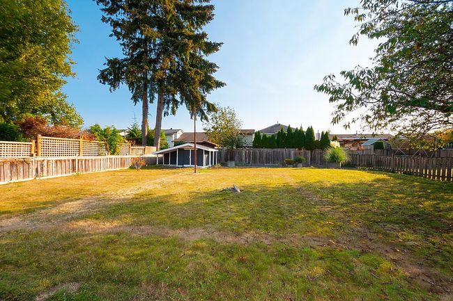 View of fenced backyard | Image 35