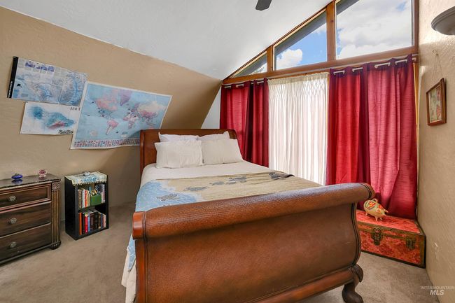 Bedroom with carpet, lofted ceiling, and a ceiling fan | Image 36