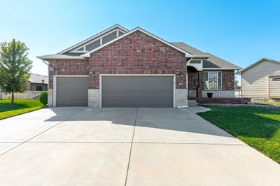 Front facade featuring a front lawn and a garage | Image 1